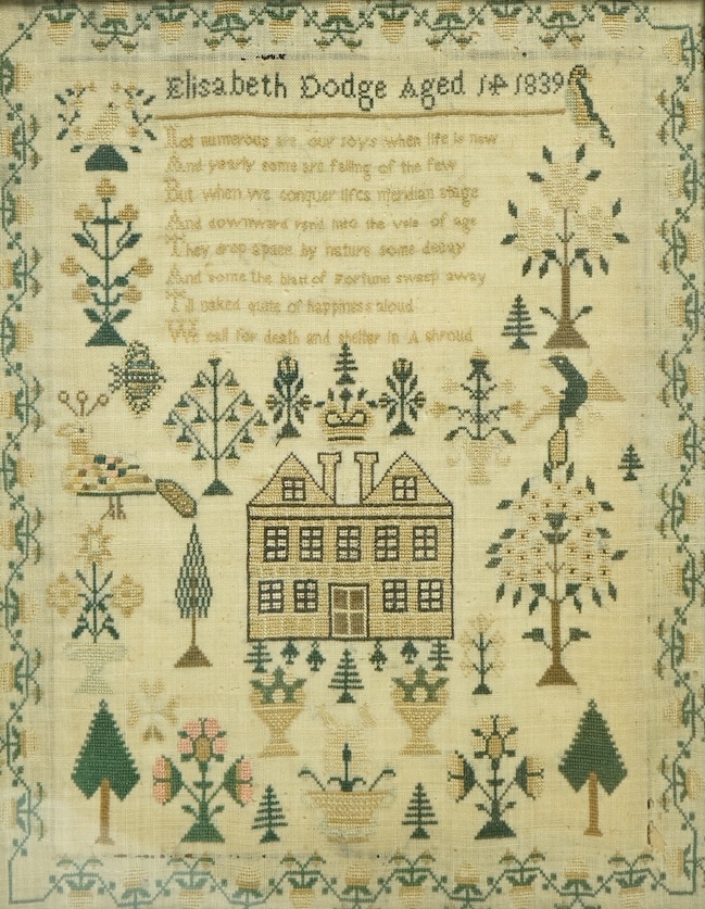 Framed needlework sampler, dated 1839, by Elizabeth Dodge ages 14 years. Worked with spot motifs of a house, crown, peacock, birds, trees and flowers with floral border. 31,5cm wide x 40.5cm high. Condition - some moth h